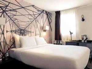 une chambre avec un grand lit blanc et une fenêtre dans l'établissement Mercure Paris Malakoff Parc des Expositions, à Malakoff 22 autres photos