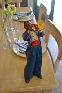 a figurine of a man playing a saxophone on a table at Xanthippi Hotel in Souvala