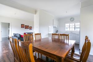 a kitchen and dining room with a wooden table and chairs at Shirley Shores Sorrento in Sorrento