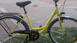 a yellow bike parked on the side of a street at L'incanto Di Boccadarno in Marina di Pisa