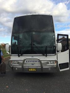 a tour bus parked on the side of a road at Tumut Valley Motel in Tumut