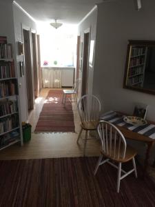 uma sala de estar com uma mesa e 2 cadeiras e uma sala de jantar em Borgholm Rum Centralt em Borgholm