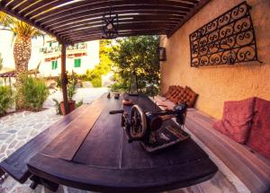a large wooden table with a sewing machine on a patio at Vagia Traditional, Aegina Island in Vaia