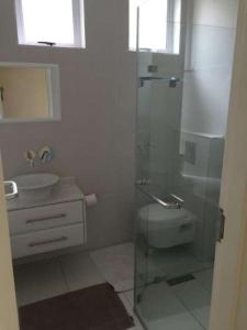 a bathroom with a shower and a toilet and a sink at 20 Mallorca Duplex in Umdloti