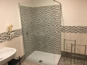 a bathroom with a glass shower with a sink at Simonetta's Rooms in Noto +33 photos