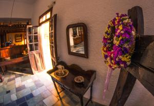 a room with a flower wreath on a wall with a table at Vagia Traditional, Aegina Island in Vaia