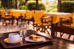 a tray with a plate of food and a cup of coffee at Vagia Traditional, Aegina Island in Vaia