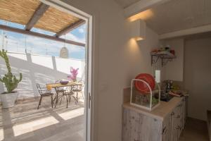 a kitchen with a view of a patio with a table at Casa Martina in Monopoli +32 photos