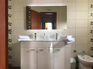a white bathroom with a sink and a mirror at Villa Nora in Tučepi +103 photos