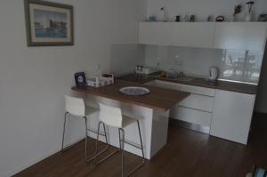 a small kitchen with a counter and stools in it at Apartment Maria in Neum