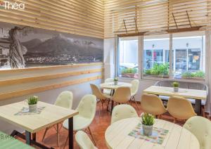 a restaurant with tables and chairs and a mural on the wall at Marianna Hotel in Alexandroupoli