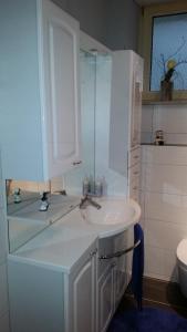 a white bathroom with a sink and a toilet at Ferienwohnung Rummel Selb in Selb