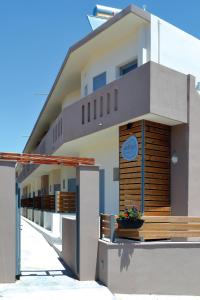 a white building with a porch and a balcony at Xanthippi Hotel in Souvala