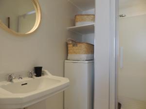 een badkamer met een wastafel, een toilet en een spiegel bij Le "Wood" in Annecy