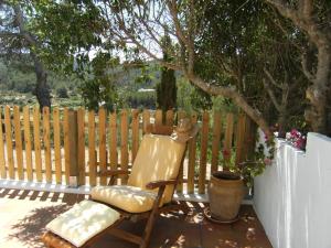 a chair sitting on a patio next to a fence at Hotel Rural Can Maries in Puerto de San Miguel