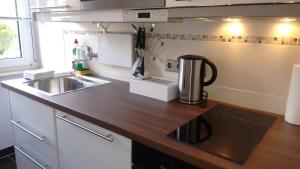 a kitchen with a sink and a coffee maker on a counter at Apartment U - relax in Leipzig