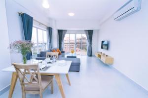 a living room with a table and a couch at Sun Apartment in Phnom Penh