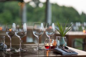 a group of wine glasses sitting on a table at Mantra Samui Resort - Adults Only in Mae Nam