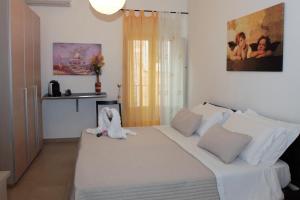 Postel nebo postele na pokoji v ubytování La Corte Di Ibla