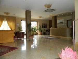 a living room with a couch and a lobby at Hotel Le Palme in Gioia Tauro