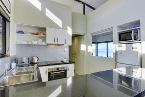 a kitchen with a sink and a stove top oven at Park Beach Retreat in Dodges Ferry