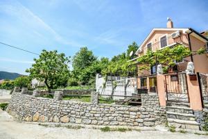 a stone wall in front of a house at Vila Loza in Herceg-Novi