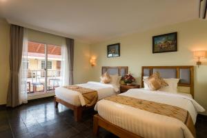 Postel nebo postele na pokoji v ubytování Grand Bayon Siem Reap Hotel