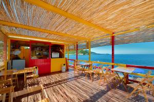 a deck of a restaurant with tables and chairs at La Capannina in Procida