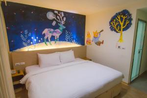 Postel nebo postele na pokoji v ubytování Legend Hotel Kaohsiung Liuhe