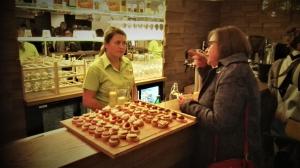 two women standing at a counter with a tray of cupcakes at Mobilehouse & Camping Lijak in Šempas