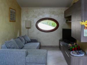 a living room with a couch and a window at La Mansarda Colorata in Rio Marina