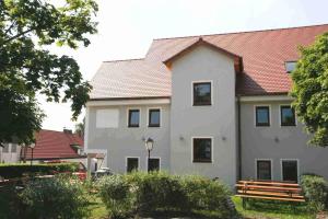 a white building with a red roof at Landgasthof Haagen in Schwabhausen bei Dachau +10 photos