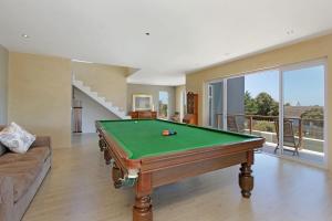 a living room with a pool table and a couch at Greenways Drive Apartment in Kommetjie