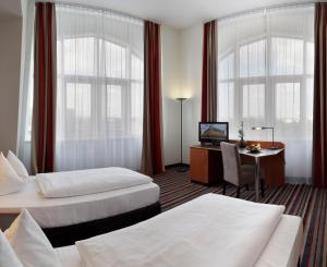Cama o camas de una habitación en H+ Hotel Leipzig