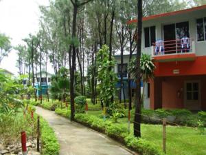 a house with people on the balcony of it at Praasad Paradise in Cox's Bazar