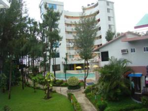 a large apartment building with a swimming pool in a yard at Praasad Paradise in Cox's Bazar