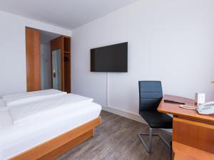Postel nebo postele na pokoji v ubytování DORMERO Hotel Dresden Airport