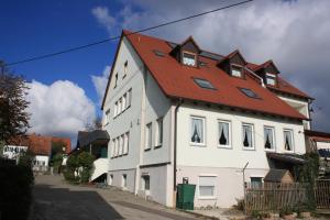 a large white house with a red roof at Landgasthof Haagen in Schwabhausen bei Dachau