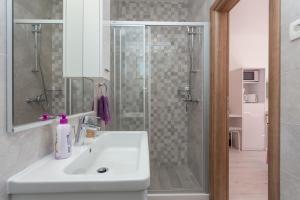 a bathroom with a white sink and a shower at Apartment & Room Ladisic in Orasac +45 photos