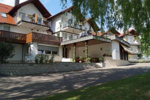 a house with balconies and a driveway at Landhotel Schellenberg in Überlingen