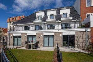 an apartment building with a patio and a table at Gartenpalais 2 in Norderney