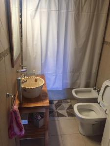 a bathroom with a sink and a toilet at Inpeuma meliquina in Villa Meliquina +49 photos