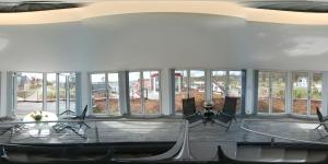 a room with large windows with tables and chairs at Ferienhaus Leuchtfeuer in Ostseebad Sellin