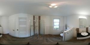 a large bathroom with a sink and a toilet at Ferienhaus Leuchtfeuer in Ostseebad Sellin +10 photos
