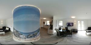a living room with a large painting on the wall at Ferienhaus Leuchtfeuer in Ostseebad Sellin