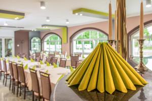 a bunch of bananas on a table in a restaurant at Europa Hotel És Étterem in Nyíregyháza