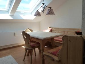 a dining room with a table and two chairs at Ferienwohnung Hörnerblick in Fischen