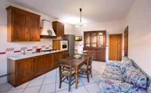 a kitchen with a table and a couch in a room at HOUSE PIAZZA 24 in Pula