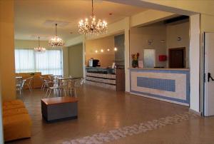 a living room with a kitchen and a dining room at Hotel Moja in Cesenatico