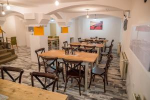 a row of tables and chairs in a restaurant at Mátyás Szállás Panzió in Szombathely